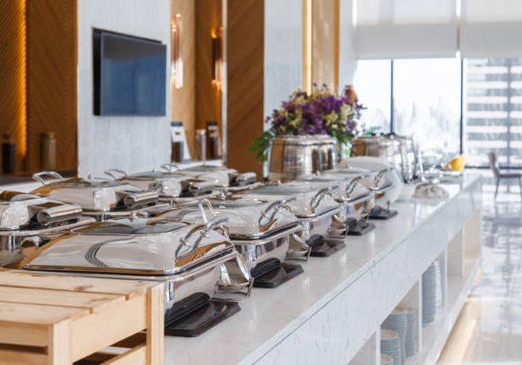 heating trays setup on the buffet line ready for service. breakfast and lunch buffet food catering banquet in hotel.