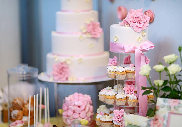 White wedding cupcake cake decorated with pink flowers